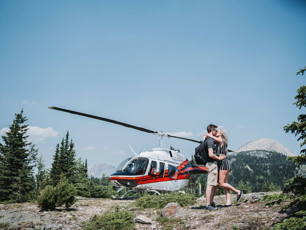 A couple taking romantic helicopter ride after elopement at Mount Engadine Lodge in Kananaskis