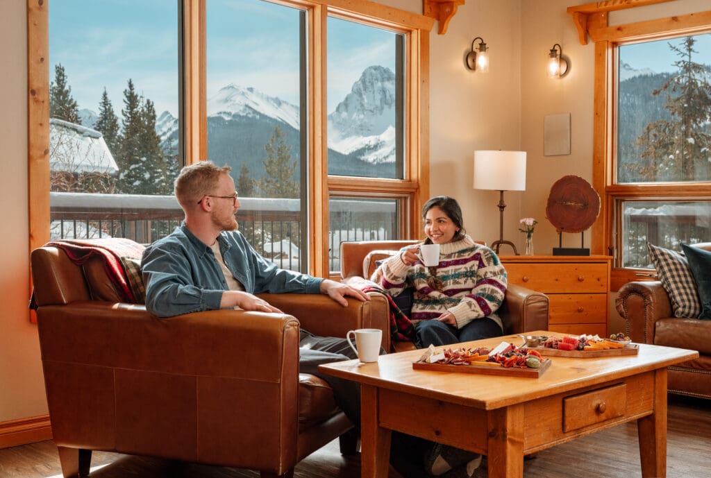 A couple enjoying afternoon tea in the lounge at Mount Engadine Lodge in Kananaskis, Alberta